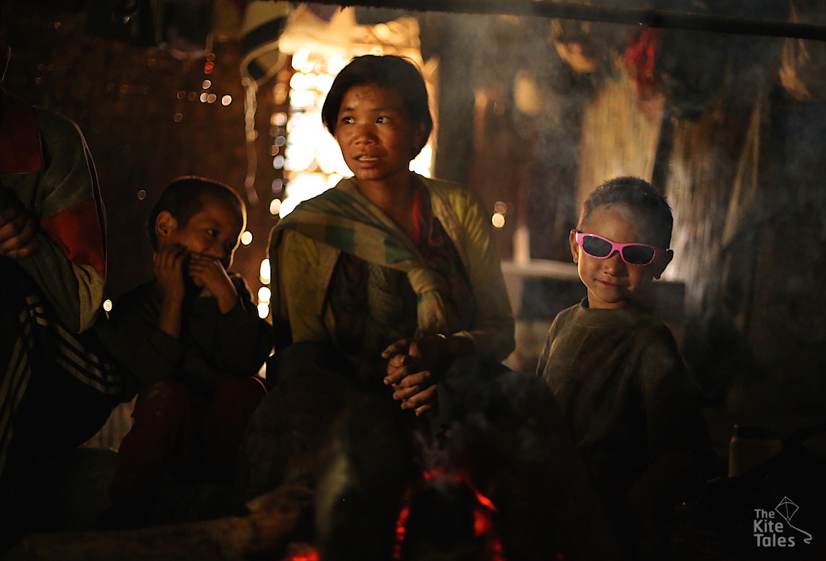 Ngòm Pok’s grandchildren at the family hearth. He has seven children  and grandchildren