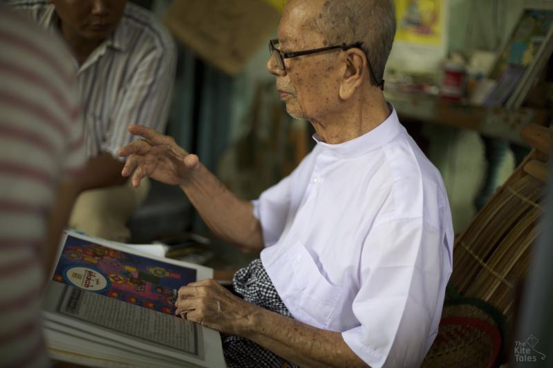 Aye Myint showing his portfolio at his home