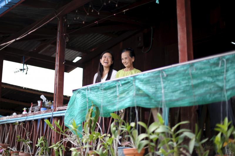 May Than at home with her youngest daughter