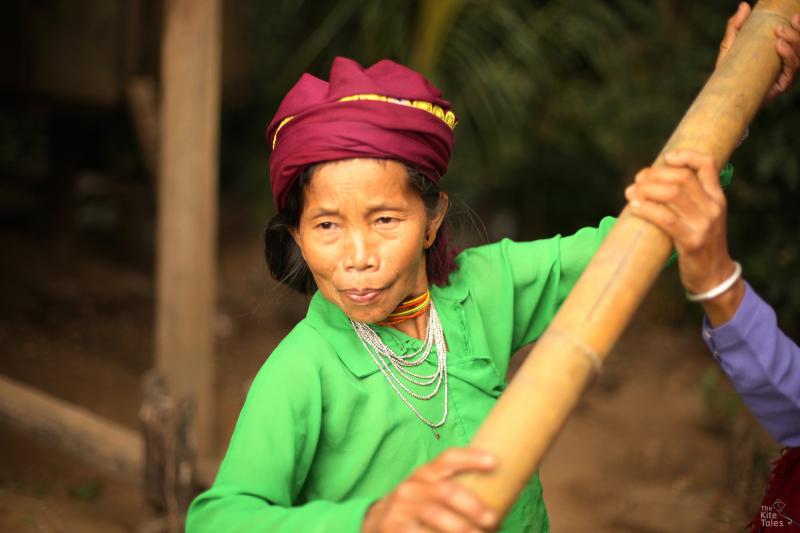 Villagers pound the rice by hand using an ancient technique